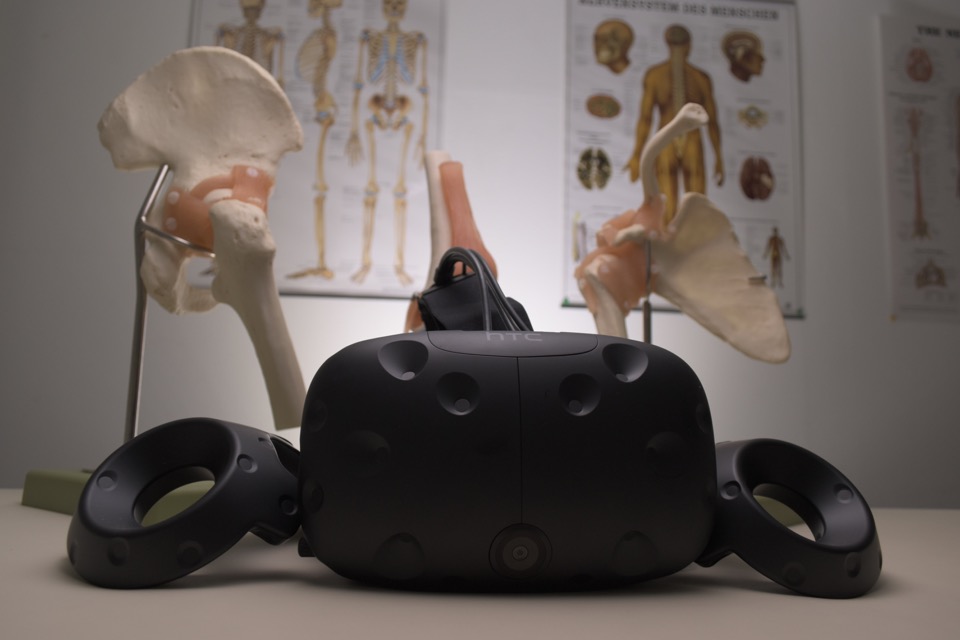 Virtual reality headset beside anatomical models in a treatment room